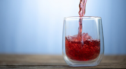 Grape apple juice is poured into a glass