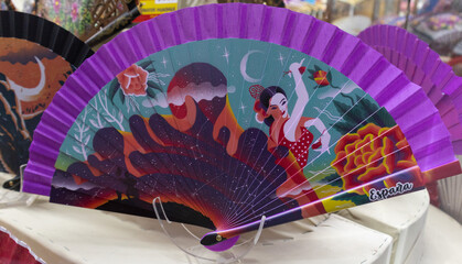 purple Hand fan in a souvenir shop with Spanish Seville flamenco dancer ballerina