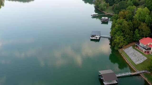 Aerial videoof a waterfront lake home with floating boat dock on Tims Ford Lake in Tennessee.