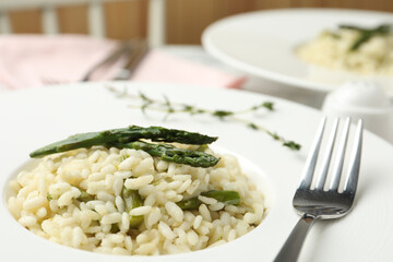 Delicious risotto with asparagus in plate, closeup