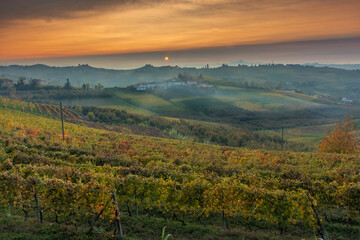 Amazing sunset over the Langhe, famous vineyard UNESCO area of Piedmont, Italy during autumn