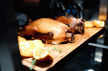 Whole duck with potatoes, plums and herbs