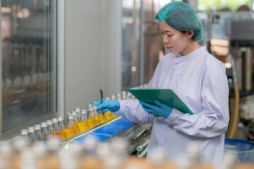 Asian professional food scientist checking and control quality of beverage