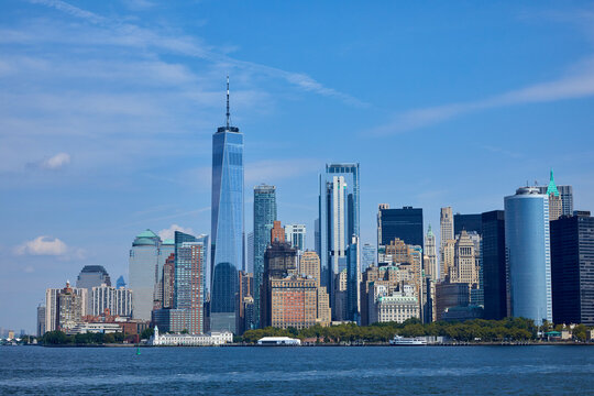 NYC skyline from a boat on a river seeing the giant city of Manhattan, NY USA on a sunny day
