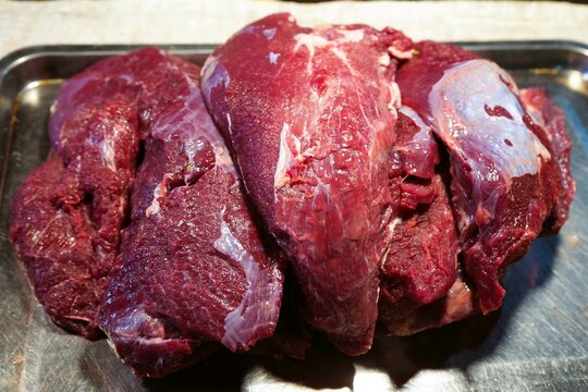 The buffalo meat is piled together in a stainless steel tray. selling in the morning market