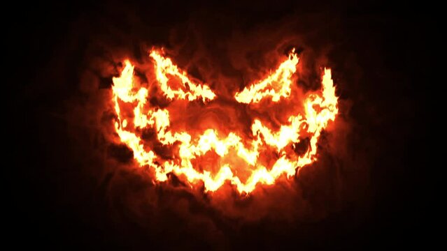 Halloween pumpkin in fire. Jack-o-lantern smile and scary eyes. Halloween concept.