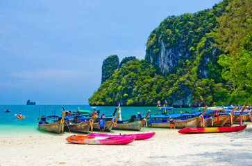 Thai traditional wooden longtail boat and beautiful sand beach at Koh Hong island in Krabi province, Thailand.