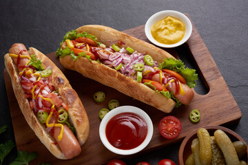 Gourmet grilled all beef hot dog with sides and chips. Delicious and simple hot dogs with mustard, pepper, onion and nachos. Hot dogs fully loaded with assorted toppings on a paddle board.