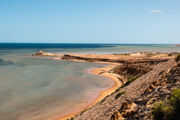 beautiful coastline with rocks and yellow sand in shark bay , Australia
