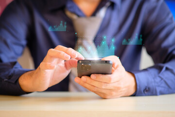 Businessman holds a smartphone and touches the screen. This is a business graph. The idea of starting a new business that succeeds