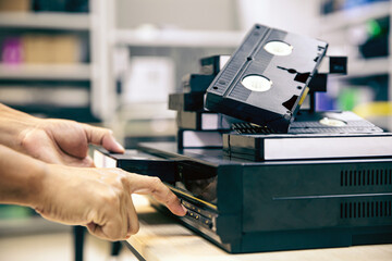 Close-up hand press button on video record playback concept of vintage electric and electronic appliances multimedia player device old fashioned.