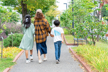 手をつないで歩く日本人の母と子供