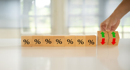 Interest rate hike and banking economics policy concept. Wooden blocks with Icon percentage and...