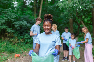 Volunteers collecting garbage from park, environmental awareness is important to save our planet