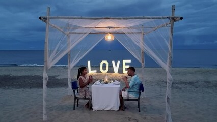 Romantic dinner on the beach of Huahin Thailand, dinner by candlelight in Hua Hin, Valentine's concept. Couple of men and women having a romantic dinner on the beach in Thailand 