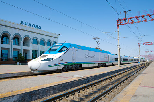 BUKHARA, UZBEKISTAN - SEPTEMBER 08, 2022: Talgo 250 "Afrosiyob" high-speed electric train at the Bukhara railway station building on a sunny day