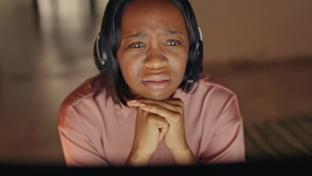 Call center agent woman on video call, getting frustrated, upset and sad in a work meeting. Female worker shocked, confused and unhappy while working online and remote in her home with laptop
