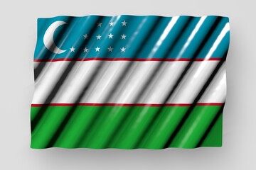 Fototapeta na wymiar cute glossy flag of Uzbekistan with big folds lay isolated on grey - any occasion flag 3d illustration..