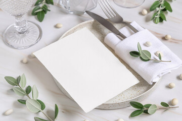 Elegant Table setting with a card decorated with eucalyptus branches close up, Wedding mockup