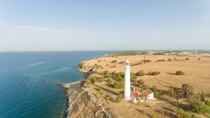 Fototapeta na wymiar Aerial view of a lighthouse situated at the coast of Aegean Sea