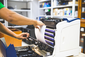 Technician hand open cover photocopier or photocopy to fix copier paper jam and replace ink...