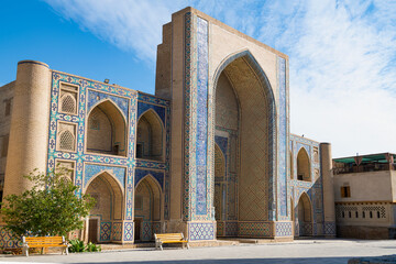 Facade of the medieval Mirzo Ulugbek madrasah (1404-1449) on a sunny day. Bukhara, Uzbekistan