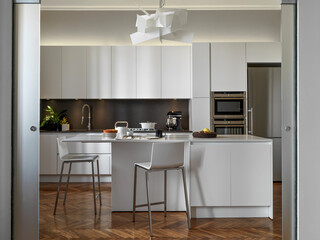 Fototapeta na wymiar internal view of a modern kitchen with an island kitchen and wooden floor