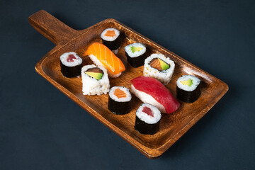 maki sushi board on dark background