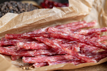 thin dried meat sausages with spices , close up