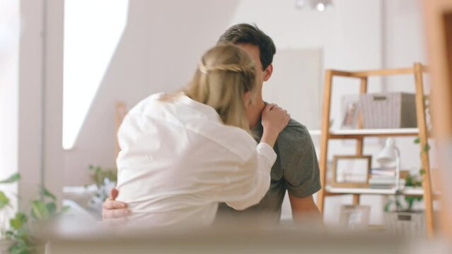 Young couple hug with love in the morning in a house apartment happy with marriage, honeymoon or valentines day. Passion, love and excited people or man and woman embrace together in home living room