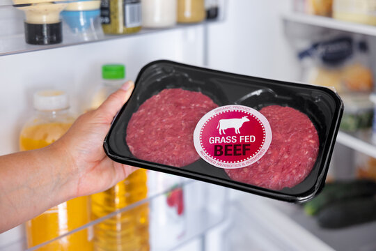 Woman Holding Package Of Grass Fed Beef Hamburger Meat