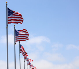 A row of American flags with copy space on the side.