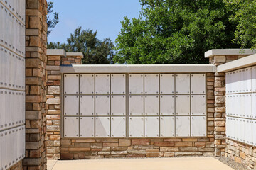 Niches on a Columbarium for cinerary urns at a cemetery. - obrazy, fototapety, plakaty