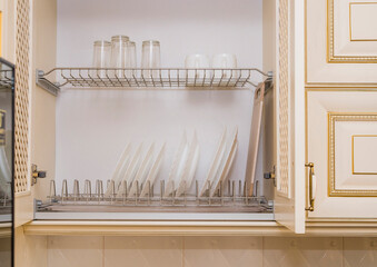 Kitchen cabinet: inside plates, glasses and two white cups