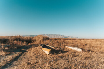 Old and abandoned wooden fishing boats on the dry lake