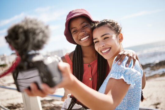 Women friends, influencer and summer selfies on live streaming holiday, beach travel and video podcast for social media in Miami Florida. Happy gen z young people taking photos at promenade outdoors
