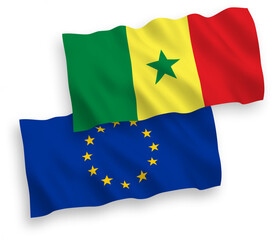 National vector fabric wave flags of European Union and Republic of Senegal isolated on white background. 1 to 2 proportion.