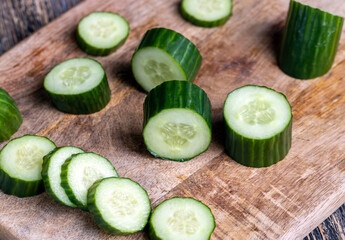 Sliced green cucumber while cooking salad