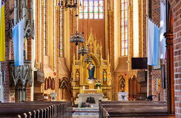 Main nave with altar and presbytery of historic Holy Mary gothic Kosciol Mariacki church in old...