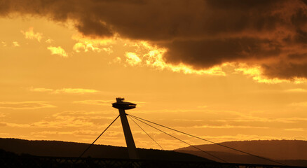 Silhoutte UFO bridge in front of angry sunset