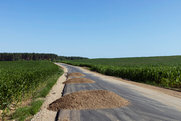 Fototapeta premium Construction and repair of a new highway in rural areas