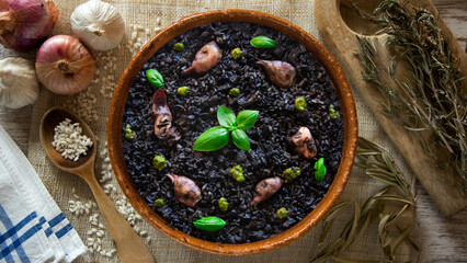 Black paella with squid and pistachio pesto. Tapa paella typical recipe from the Spanish Mediterranean coast.