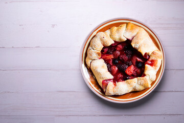 Red fruit galette with blackberries, strawberries, raspberries. Traditional French recipe.
