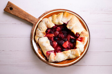 Red fruit galette with blackberries, strawberries, raspberries. Traditional French recipe.