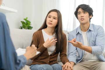 Psychology, depression asian young couple, patient consulting problem mental health with psychologist, psychiatrist at clinic together, husband encouraging by holding hand of wife, therapy health care