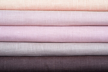 A stack of colored pastel linen fabric, close-up