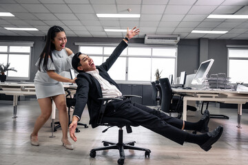 Businessman having fun and push office chair