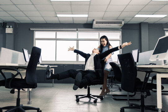 Businessman Having Fun And Push Office Chair