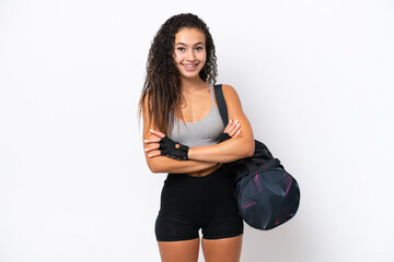 Young sport Arab woman with sport bag isolated on white background keeping the arms crossed in...