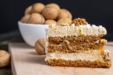 a piece of cake with buttercream and walnuts